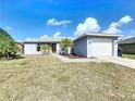 Charming single-story home with a well-maintained yard, driveway, and two-car garage at 119 Cory Ct, Auburndale, FL 33823