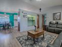 Comfortable living room featuring wood laminate flooring, a cozy built-in nook and stylish furnishings at 11915 Cr 680, Webster, FL 33597