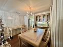 Traditional dining room featuring a table with chairs, wood floors, and a chandelier at 133 Hibiscus Way, Leesburg, FL 34748