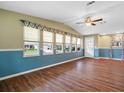 Bright, airy living room featuring wood floors, neutral paint, and ample natural light at 1417 E Schwartz Blvd, The Villages, FL 32159