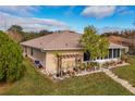 A well-maintained backyard featuring a small pergola and a variety of potted plants at 1739 Lake Villa Dr, Tavares, FL 32778