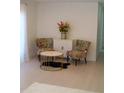Cozy living room showcasing colorful accent chairs, a modern coffee table, and elegant floral decor at 1846 Fruitland Park Blvd, Fruitland Park, FL 34731