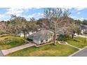 Aerial view of a well-manicured property featuring a circular driveway and lush green landscaping at 19215 Park Place Blvd, Eustis, FL 32736