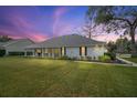 Charming home exterior with a sprawling lawn and a covered porch, perfect for outdoor relaxation at 19215 Park Place Blvd, Eustis, FL 32736