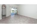 Bright living area showcasing tile floors and sliding glass doors leading to a screened-in lanai at 2041 Park Forest Blvd, Mount Dora, FL 32757