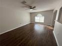 Spacious living room with dark wood-look flooring, and neutral paint at 2320 Whispering Trails Pl, Winter Haven, FL 33884