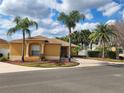 Inviting single-Gathering home with lovely curb appeal, palm trees, and a well-manicured front yard at 2668 Alandari Ln, The Villages, FL 32162