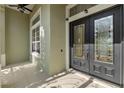 Elegant front entryway featuring double doors with decorative glass and sidelights at 27710 Snow Orchid Ct, Leesburg, FL 34748