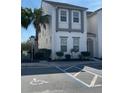 Well-maintained two-story home with a white exterior and a landscaped yard at 294 Captiva Dr, Davenport, FL 33896