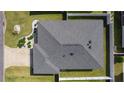 Birds eye view of roof, driveway, and landscaping in fenced back yard at 3356 Blaise Ter, The Villages, FL 32163