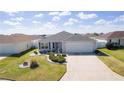 Charming single-story home with well-manicured lawn, attractive landscaping, and attached garage at 3356 Blaise Ter, The Villages, FL 32163