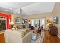 Spacious living room featuring hardwood floors, neutral walls, lots of natural light, and modern furnishings at 39131 Griffin Lndg, Lady Lake, FL 32159