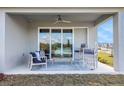 Cozy covered patio with ceiling fan, neutral furniture set on a gray patterned outdoor rug at 5306 Marshelder St, Apopka, FL 32712