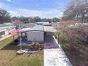 Aerial view of a charming single-story home with well-manicured yard and compass-design driveway in a pleasant neighborhood at 730 Royal Palm Ave, The Villages, FL 32159