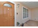 Charming front entrance with a decorative door, a window, and a classic exterior light fixture at 9150 Se 153Rd Pl, Summerfield, FL 34491