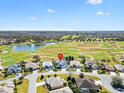 Expansive aerial view of a community surrounding a golf course and lake at 1044 Alcove Loop, The Villages, FL 32162