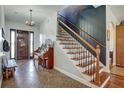 Welcoming foyer with staircase, and a decorative chandelier creating a grand entrance at 10909 Mattioda Rd, Groveland, FL 34736