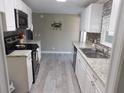 Bright kitchen with stainless steel appliances, granite countertops, and ample white cabinetry, creating a modern culinary space at 110 Oleander Cv, Leesburg, FL 34748