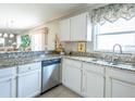 Bright kitchen featuring white cabinets, granite countertops, and stainless steel appliances at 1137 Alfredo Ave, The Villages, FL 32159