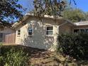 Side view of home with updated windows and a textured exterior finish at 13 Spring Loop, Ocala, FL 34472