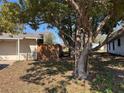 Home's side yard features a privacy fence with some shade trees at 13 Spring Loop, Ocala, FL 34472