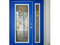 Elegant blue front door with glass detailing offering privacy and style at 1508 Dellano Way, The Villages, FL 32159