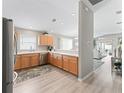 Bright kitchen featuring stainless steel appliances and light wood cabinets at 1558 Summerchase Loop, The Villages, FL 32162