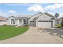 Charming single-story home with well-maintained lawn and a two-car garage at 17899 Se 115Th Cir, Summerfield, FL 34491