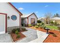 Inviting front yard features stone walkway, mature landscaping, and a delightful water fountain feature at 1914 Antonia Pl, The Villages, FL 32159