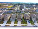 Aerial view of a neighborhood with a two-story house outlined in yellow at 2024 Hemingway Cir, Groveland, FL 34736