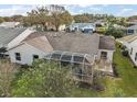 Aerial view of the backyard with a screened-in patio, perfect for outdoor entertaining and relaxation at 25073 Riverwalk Dr, Leesburg, FL 34748