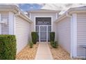 Inviting front entrance with a secure gate and manicured stone landscaping at 2533 Links Ct, The Villages, FL 32162