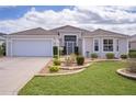 Charming single-story home with well-maintained landscaping and a two-car garage at 2533 Links Ct, The Villages, FL 32162