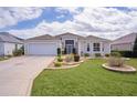 Charming single-story home with well-maintained landscaping and a two-car garage at 2533 Links Ct, The Villages, FL 32162