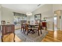 Formal dining room with hardwood floors, large windows, and a stylish chandelier at 26148 Glen Eagle Dr, Leesburg, FL 34748