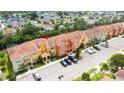 Aerial view of townhomes showcasing tiled roofs, parking, and landscaping in a well-planned community at 2959 Banana Palm Dr, Kissimmee, FL 34747