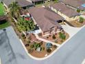 Aerial view of a well-kept single-story home with a manicured lawn and neighborhood landscape at 3172 Amberly Ct, The Villages, FL 32163