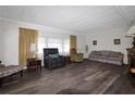 Spacious living room featuring hardwood floors, a fireplace, and comfortable seating at 354 Hawthorne Blvd, Leesburg, FL 34748