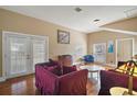 Spacious living room featuring hardwood floors, neutral paint, French doors, and ample natural light at 401 S 6Th St, Leesburg, FL 34748