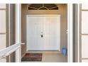 Home's double door front entry with secured lock, a 'Welcome' mat, and arched window above at 5049 Harbour Dr # 1, Oxford, FL 34484