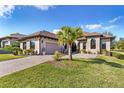 Stunning one story home featuring an attached garage, landscaping, and a brick paver driveway at 5413 Sandy Hill Ln, Lady Lake, FL 32159