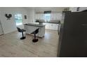 Bright kitchen features a central island with bar seating and sleek, modern appliances at 654 Nw 9Th Ave, Webster, FL 33597
