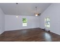 Bright and airy living room featuring wood floors, vaulted ceilings, and large windows at 654 Nw 9Th Ave, Webster, FL 33597