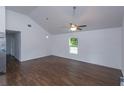 Bright living room with vaulted ceilings, wood floors, a ceiling fan and natural light at 654 Nw 9Th Ave, Webster, FL 33597