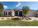 Charming single-story home features brick driveway and beautiful landscaping at 8682 Bridgeport Bay Cir, Mount Dora, FL 32757