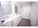 Modern bathroom featuring double sinks, white marble countertops, and a walk-in shower at Lot 19 Indian Estates Cr 423, Lake Panasoffkee, FL 33538