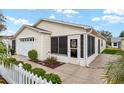 Home exterior highlighting a screened entrance, clean lines, and well-maintained landscaping at 2277 Whisper St, The Villages, FL 32162