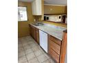 Cozy kitchen with stainless steel sink, white dishwasher, and light countertops at 100 W Idlewild Ave, Eustis, FL 32726