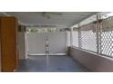 Enclosed patio with privacy lattice features a ceiling fan for those hot summer days at 100 W Idlewild Ave, Eustis, FL 32726