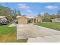 Well-maintained single-story home with a spacious driveway and neatly kept lawn at 1119 Cr 457, Lake Panasoffkee, FL 33538